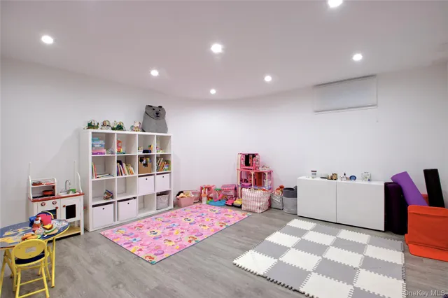 a playing room with furniture and a book shelf