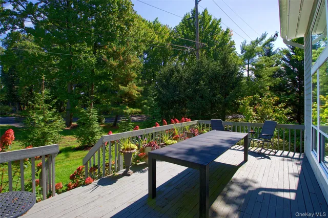 a view of a balcony with wooden floor and outdoor seating