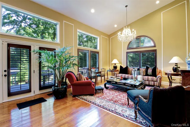 a living room with furniture fireplace and large windows