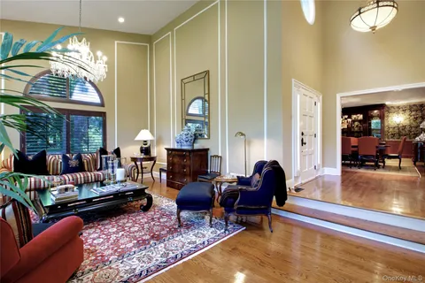 a living room with furniture and a large mirror