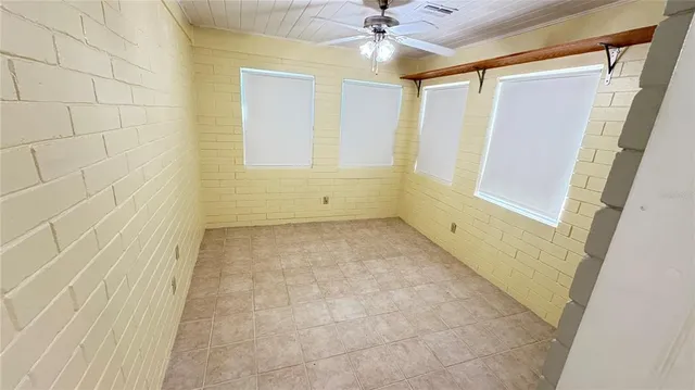 a view of room with window and ceiling fan