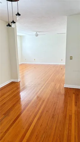 a view of a room with wooden floor