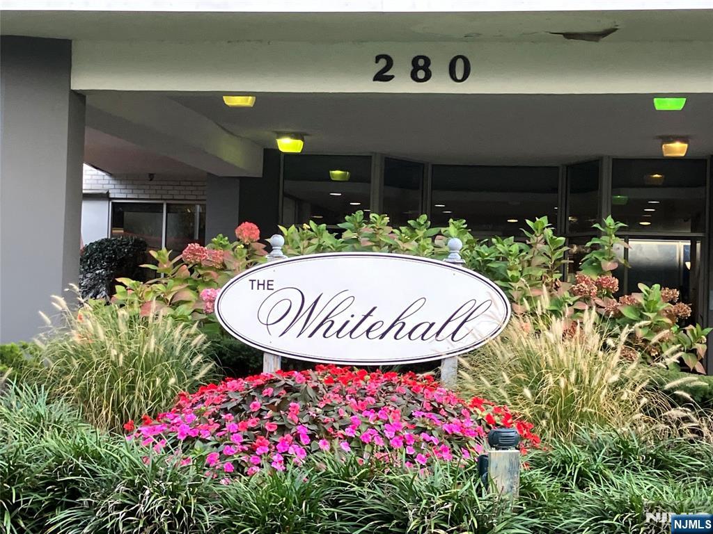 280 Prospect Avenue, Unit 11H Hackensack, NJ 07601 - Photo 1 of 20 a front view of a house with a fountain and flowers