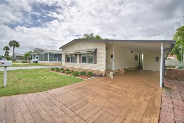 a view of a house with a backyard