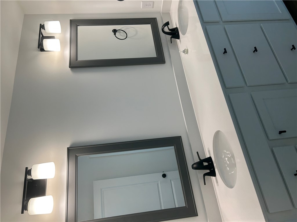 202 Bellflower Lane Pendleton, SC 29670 - Photo 20 of 27 A well-lit primary bathroom features double vanity sinks and ample cabinet storage.