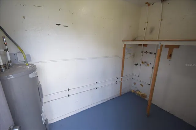 a view of storage and utility room with closet