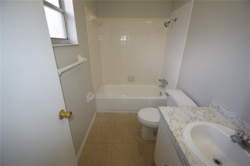 117 Leelon Road, Unit 117 Lakeland, FL 33809 - Photo 5 of 13 a bathroom with a granite countertop sink toilet and shower
