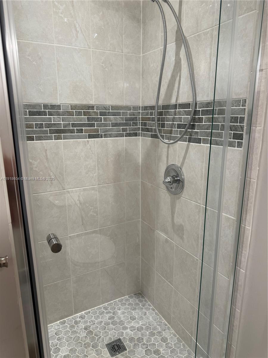 17449 Southwest 143rd Place Miami, FL 33177 - Photo 11 of 19 a bathroom with a shower