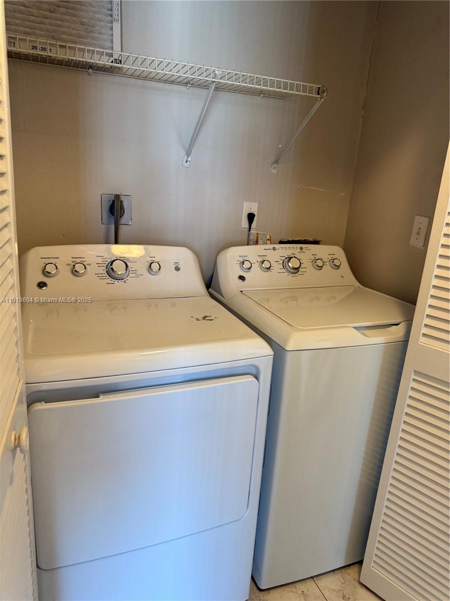 17449 Southwest 143rd Place Miami, FL 33177 - Photo 14 of 19 a utility room with dryer and washer
