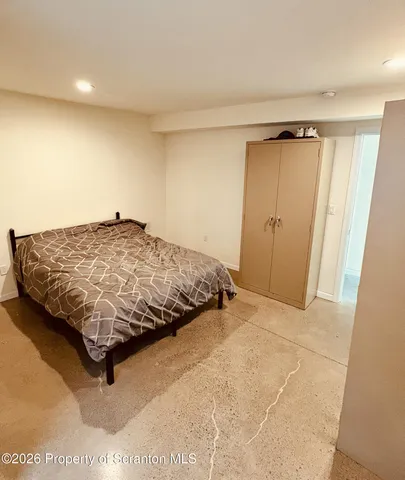 a bedroom with a bed and a dresser