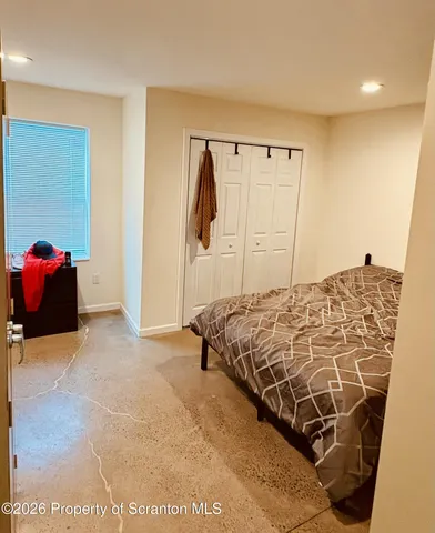 a bedroom with a bed and a walk in closet