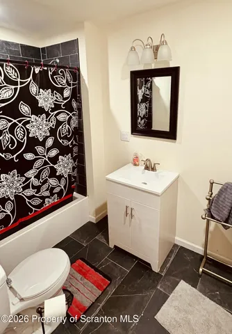 a bathroom with a toilet a sink and a mirror