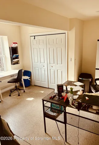 a livingroom with lounge chair and a window