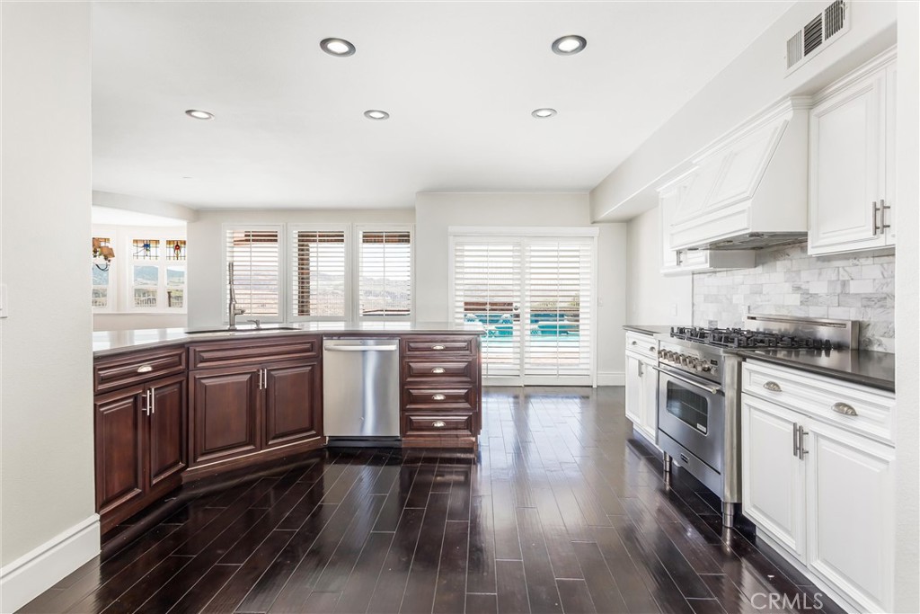 1608 Smiley Ridge Redlands, CA 92373 - Photo 22 of 84 a kitchen with granite countertop a stove top oven sink and cabinets