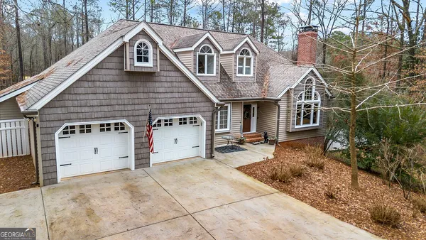a view of a house with a yard and garage