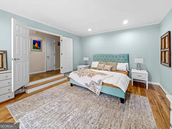 a bedroom with a large bed and a window