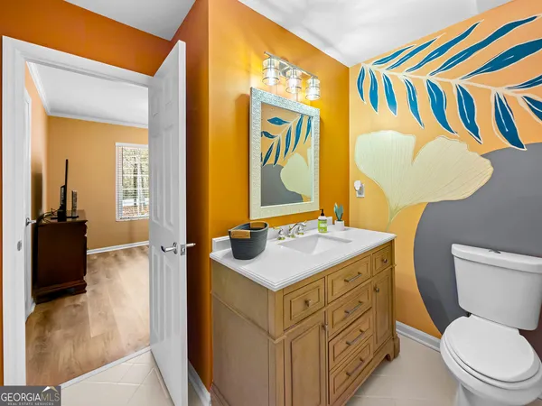 a bedroom with a bed a mirror and desk