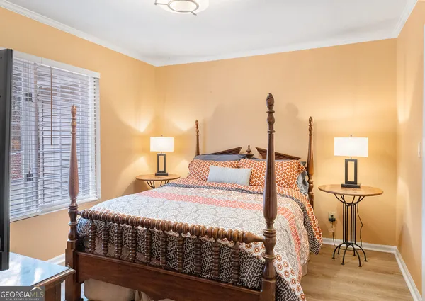a bedroom with a bed and a television