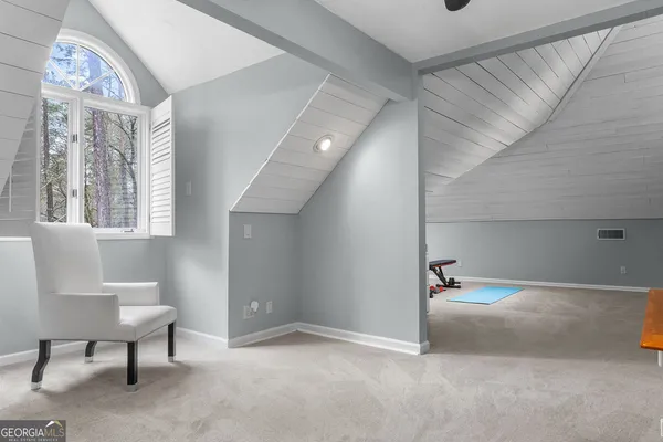 a view of storage and utility room with closet and windows