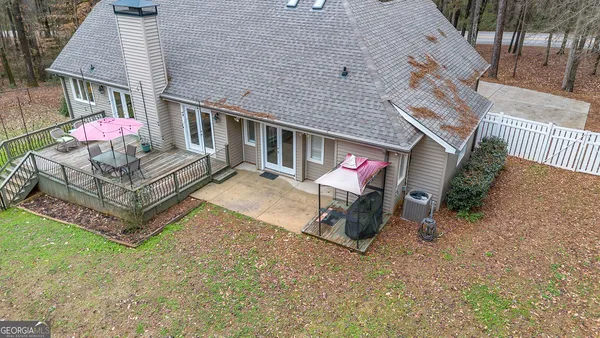an aerial view of a house with a yard and wooden fence