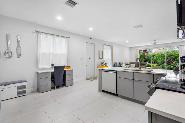 a kitchen with sink cabinets and window
