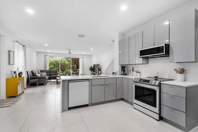 a kitchen with a sink a stove and cabinets