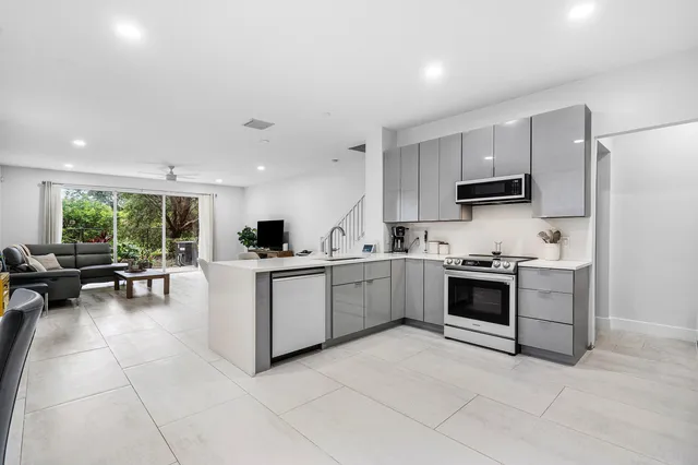 a kitchen with sink cabinets and stainless steel appliances