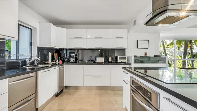 a kitchen with stainless steel appliances granite countertop a sink stove and cabinets