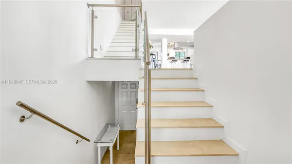 a view of staircase with white walls and windows