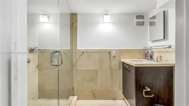a bathroom with a sink a mirror and shower