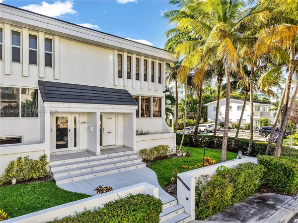 a front view of a house with a garden