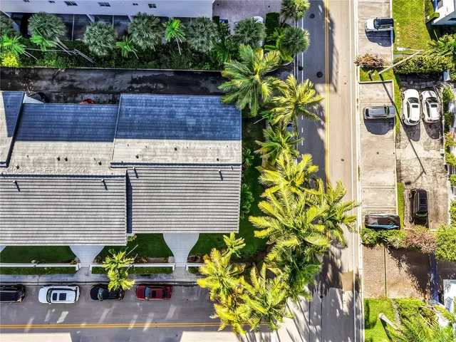 a view of a brick wall with potted plants