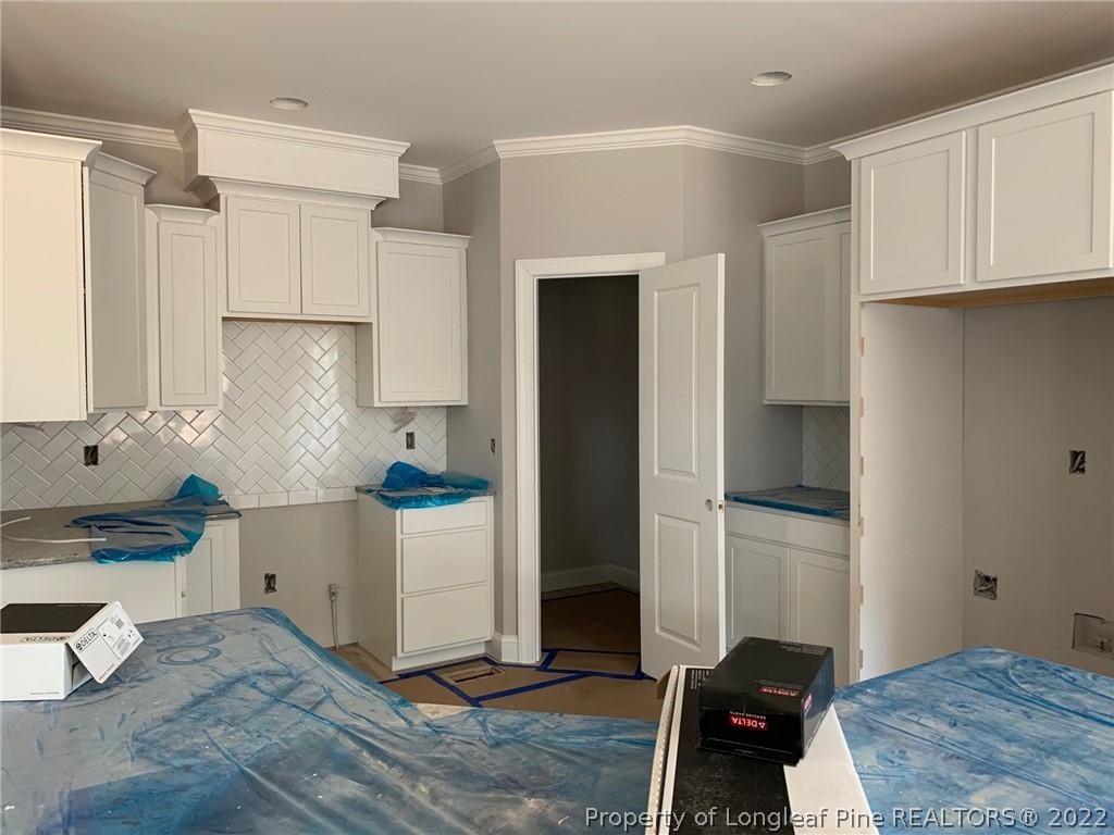 155 Crestview Road Southern Pines, NC 28387 - Photo 5 of 15 a kitchen with a refrigerator and a stove top oven