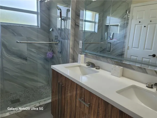 a bathroom with a sink and mirror