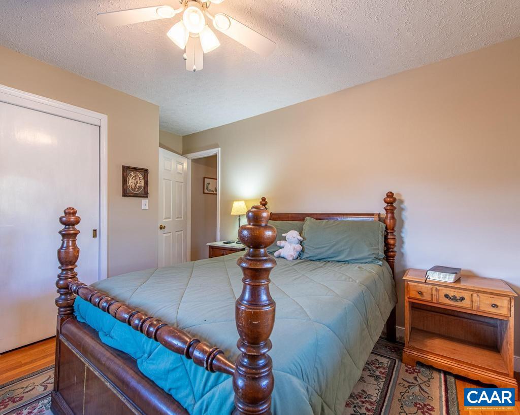 3483 West River Road Scottsville, VA 24590 - Photo 12 of 33 a bedroom with a bed and wooden floor