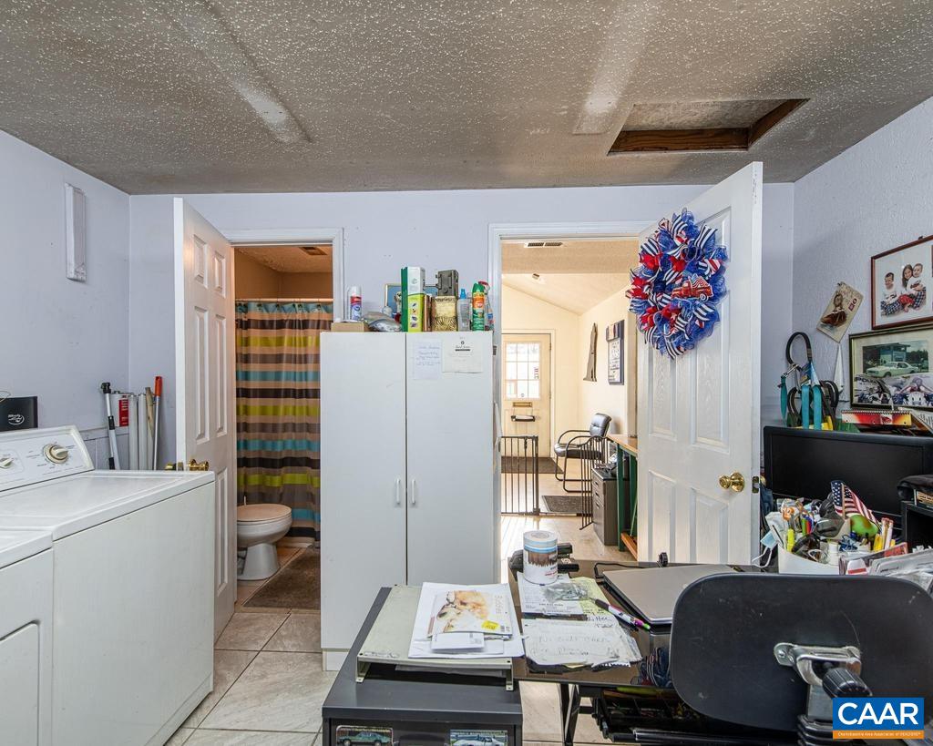 3483 West River Road Scottsville, VA 24590 - Photo 30 of 33 a room that has a couch and a table in it