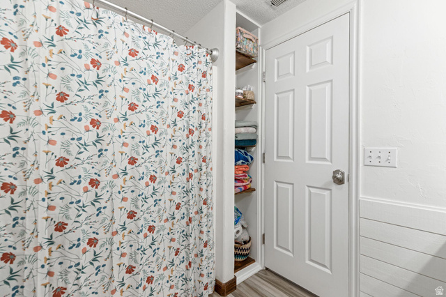 814 Mountain Road Logan, UT 84321 - Photo 27 of 42 Full bathroom with a white six-panel door, built-in wooden shelving, and shiplap wall detailing