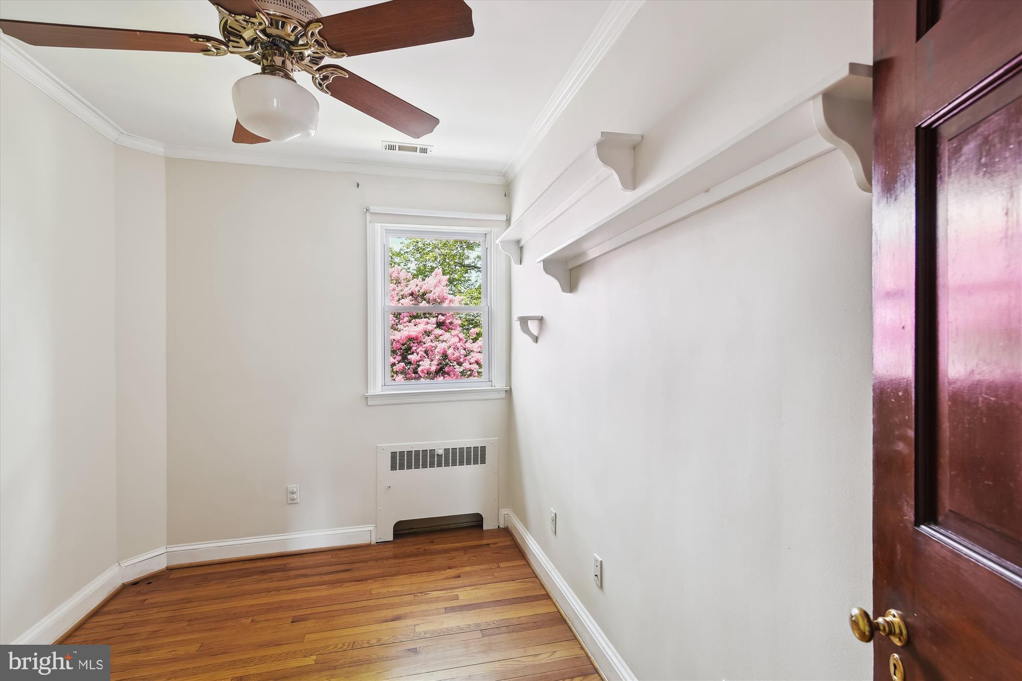 116 Murdock Road Baltimore, MD 21212 - Photo 13 of 42 a view of an empty room with wooden floor and a ceiling fan