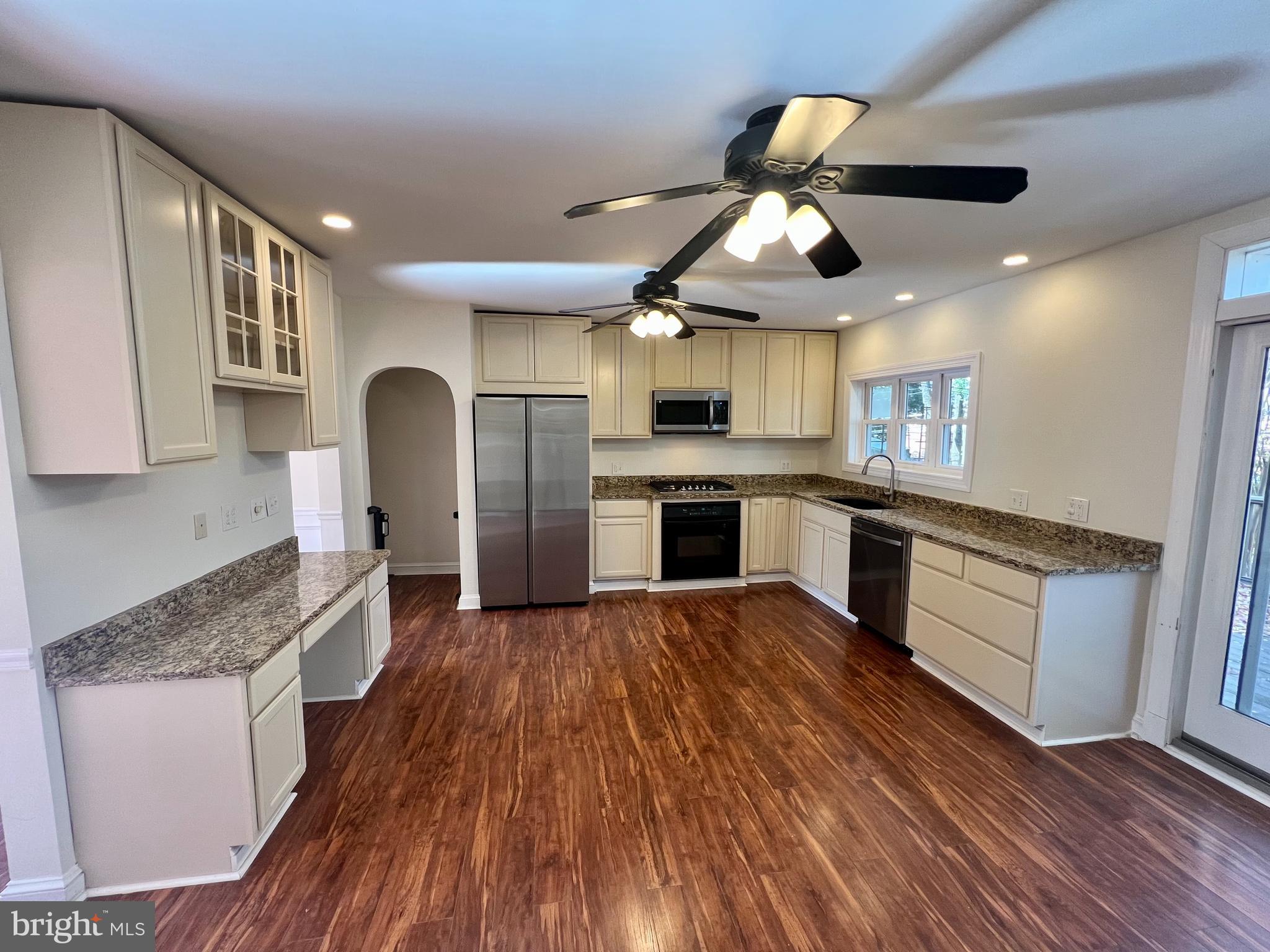 116 Murdock Road Baltimore, MD 21212 - Photo 10 of 42 a kitchen with stainless steel appliances granite countertop wooden floors and white cabinets
