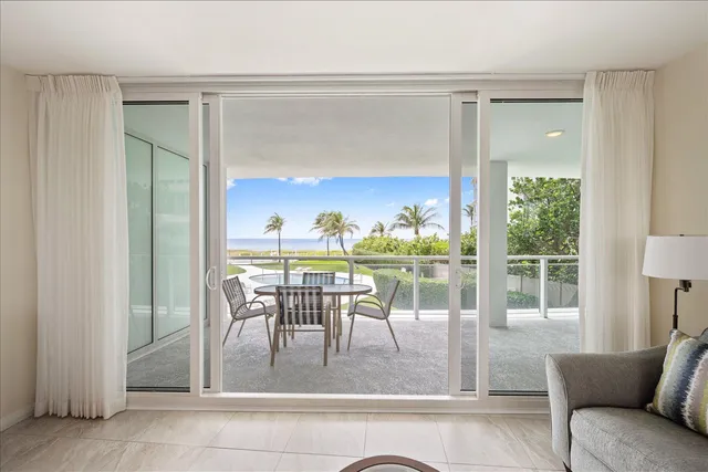 a table and chairs in patio of the house