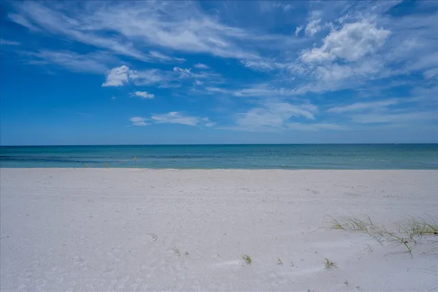 a view of swimming pool with seating space and yard in the back