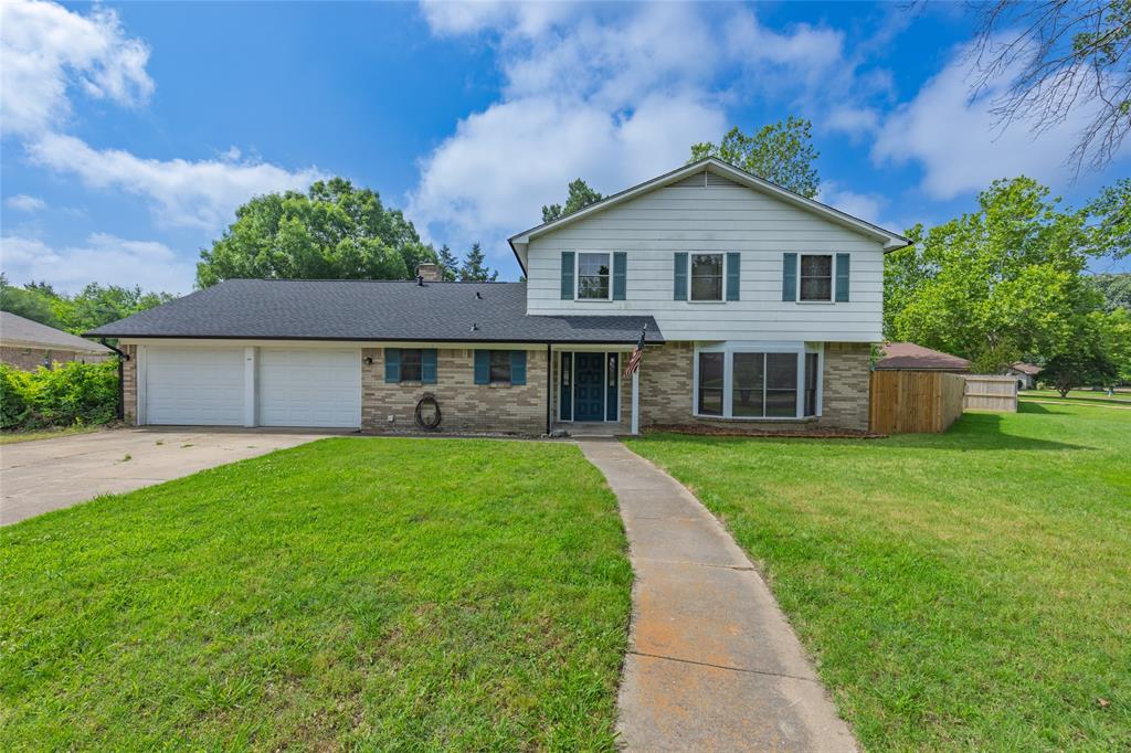 2820 Bois D'Arc Street Commerce, TX 75428 - Photo 40 of 40 a front view of a house with a yard and trees