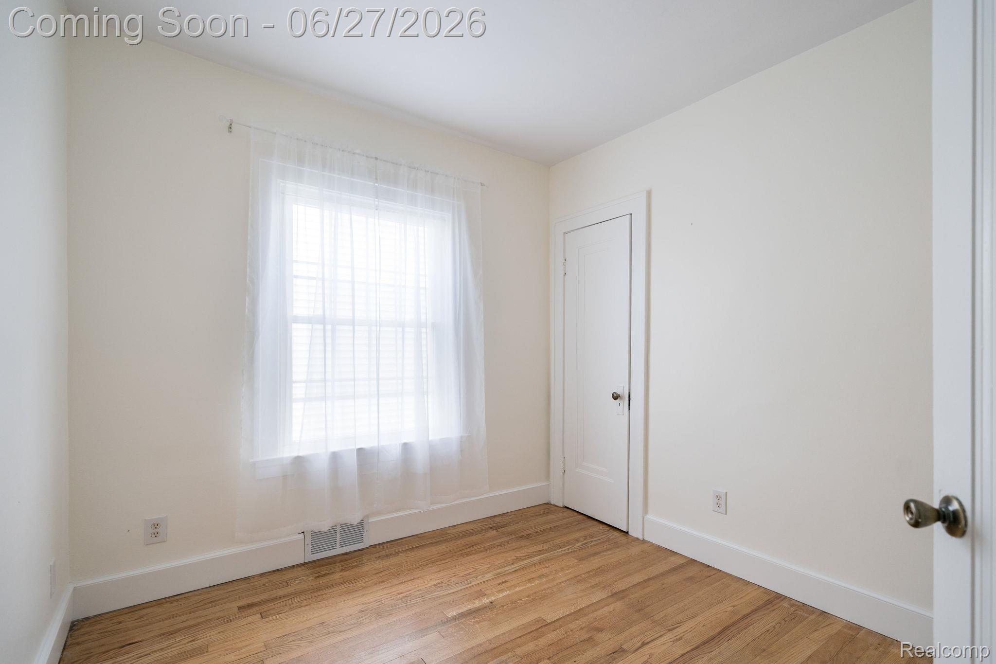 39 Mohawk Road Pontiac, MI 48341 - Photo 16 of 32 Interior room featuring wood-finish flooring, white baseboards, and neutral wall paint