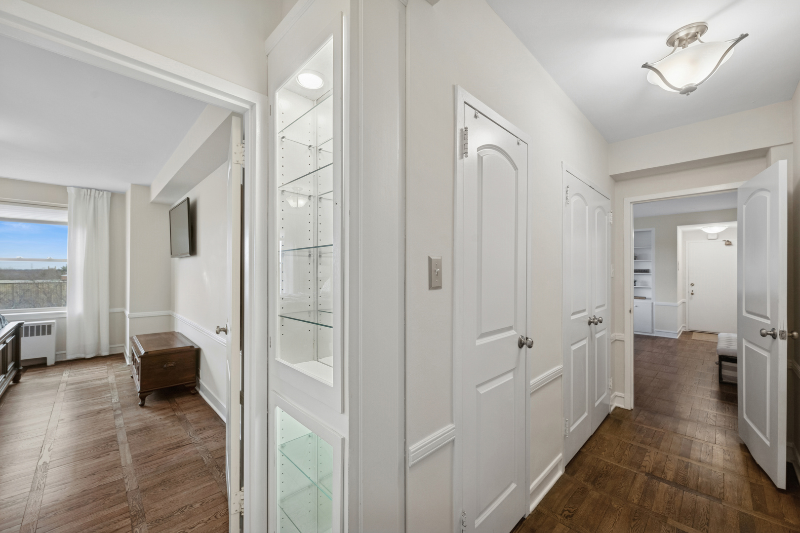 1585 Ridge Avenue, Unit 611 Evanston, IL 60201 - Photo 11 of 21 a view of a hallway with bathroom and wooden floor