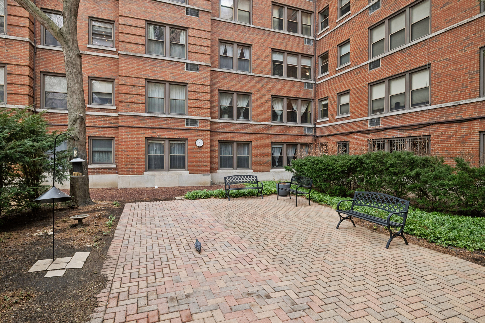1585 Ridge Avenue, Unit 611 Evanston, IL 60201 - Photo 20 of 21 a wooden bench sitting in front of a building