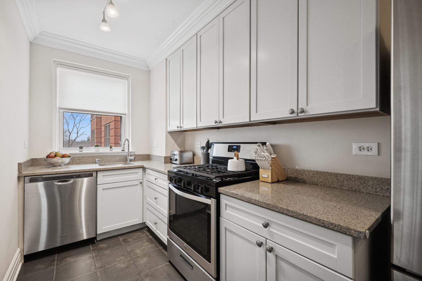 1585 Ridge Avenue, Unit 611 Evanston, IL 60201 - Photo 6 of 21 a kitchen with stainless steel appliances granite countertop a sink stove and cabinets
