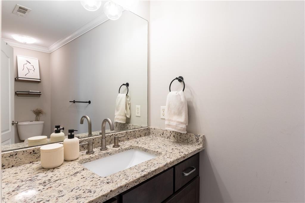 7 Chief Matthews Road, Unit 2B Decatur, GA 30030 - Photo 18 of 41 a bathroom with a granite countertop sink and a mirror
