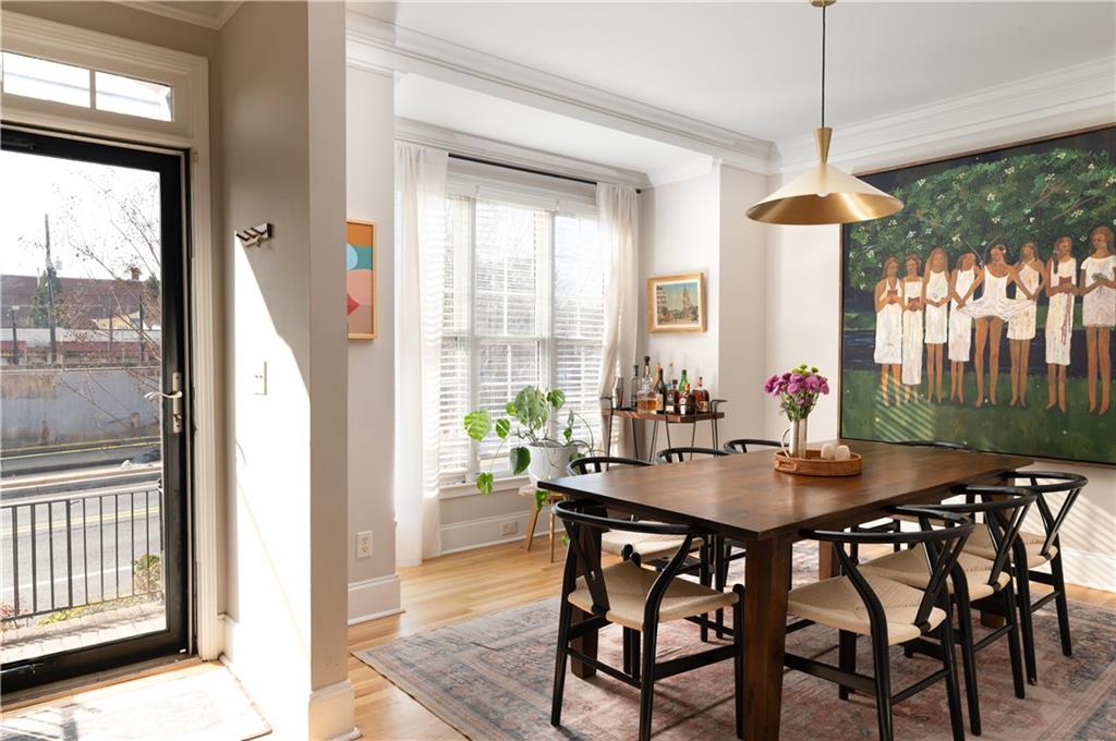 7 Chief Matthews Road, Unit 2B Decatur, GA 30030 - Photo 3 of 41 a dining room with furniture a chandelier and wooden floor