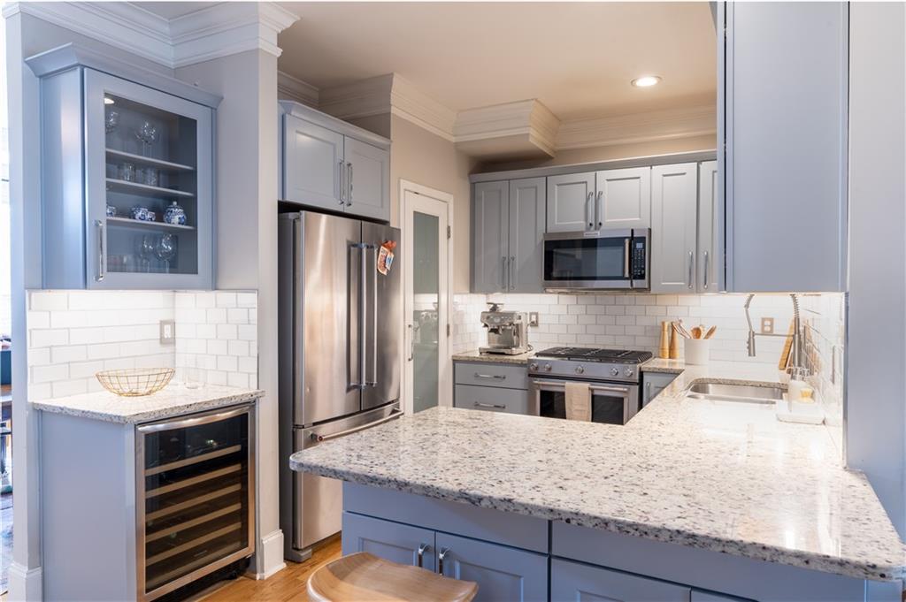 7 Chief Matthews Road, Unit 2B Decatur, GA 30030 - Photo 5 of 41 a kitchen with stainless steel appliances granite countertop a refrigerator stove microwave and sink