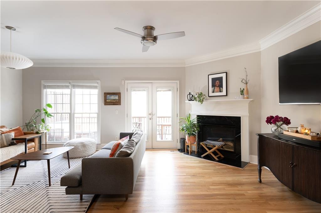 7 Chief Matthews Road, Unit 2B Decatur, GA 30030 - Photo 8 of 41 a living room with furniture a fireplace and a flat screen tv